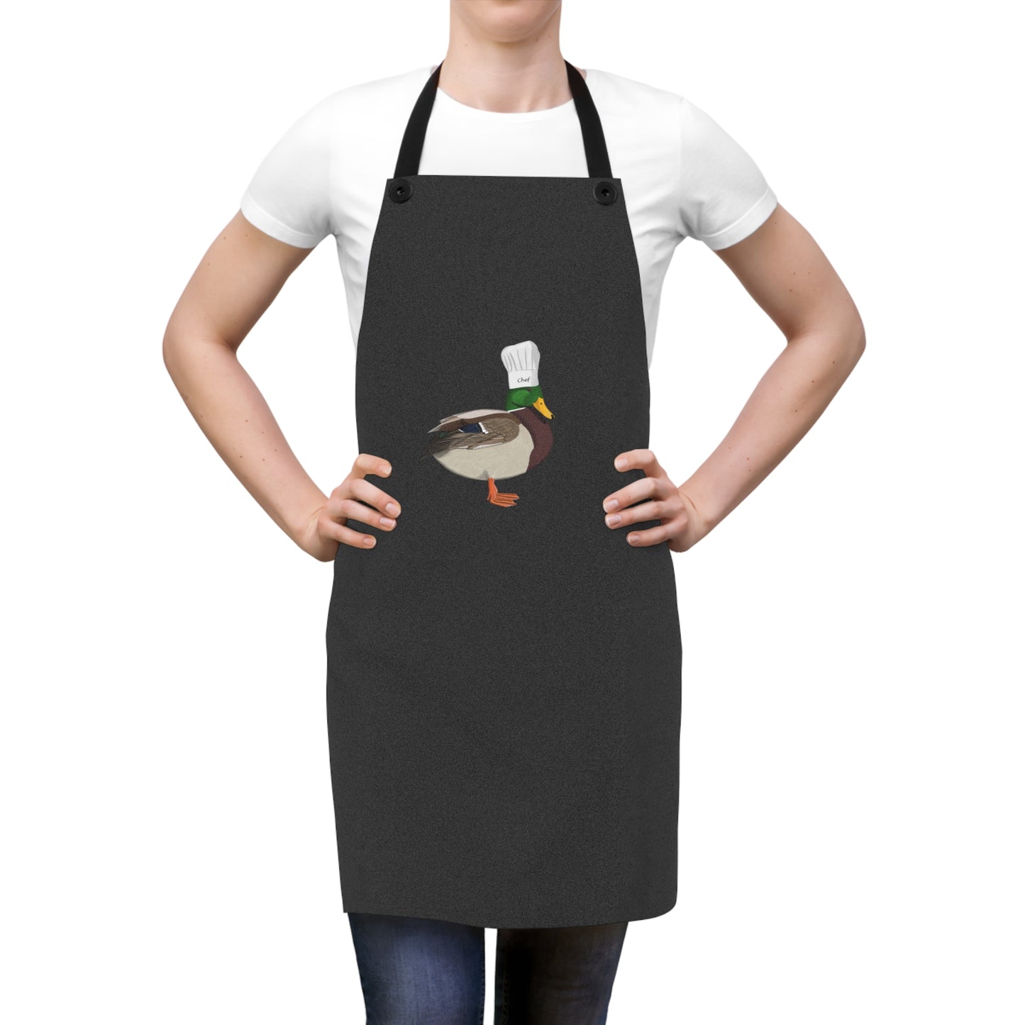 Person wearing a black apron with a duck design on a white background