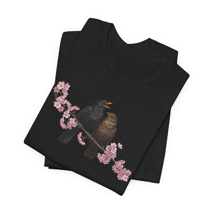 Black t-shirt with bird and cherry blossom design on a white background