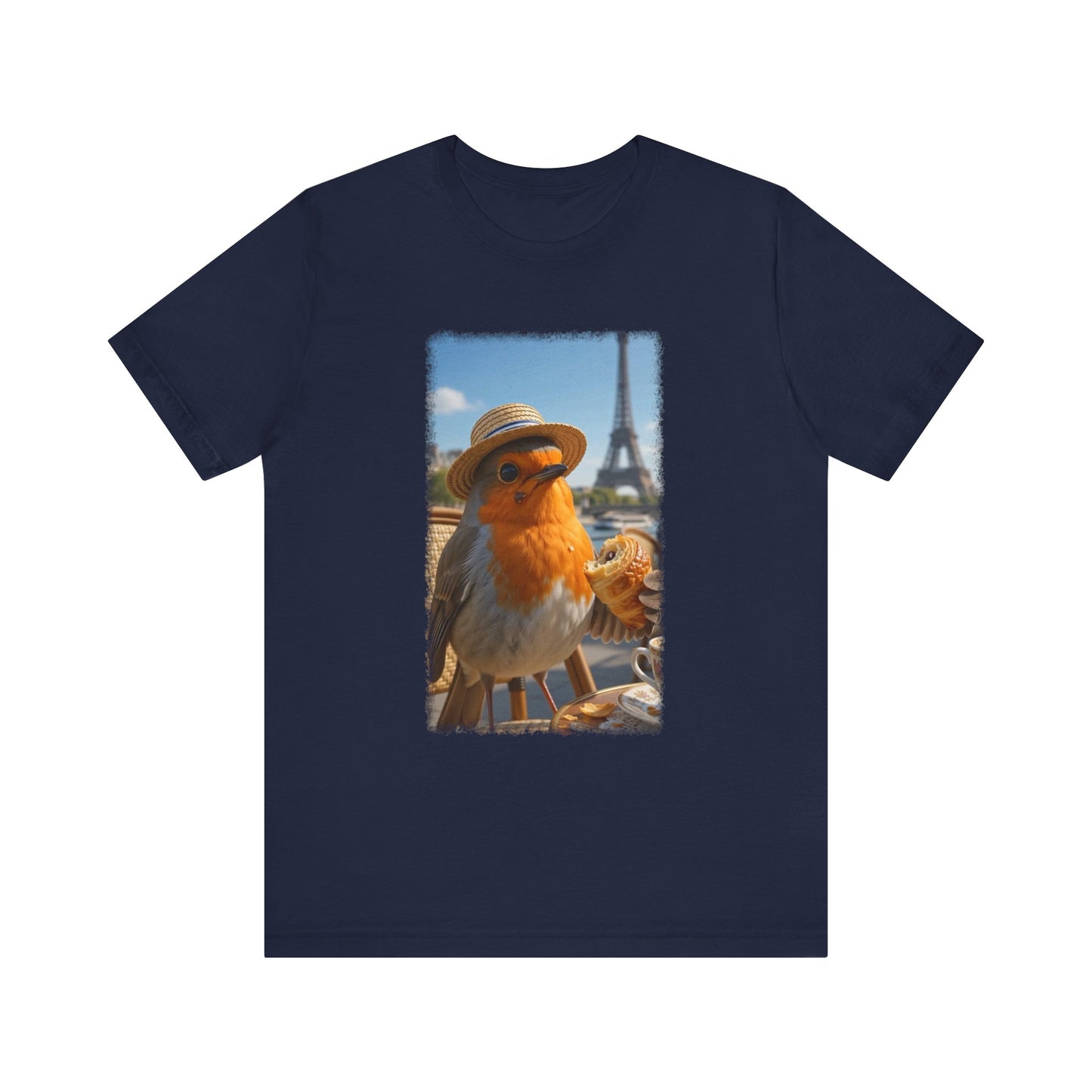 A navy blue short-sleeve crewneck t-shirt featuring a rectangular graphic print on the front. The graphic shows a robin wearing a straw hat with the Eiffel Tower and a street scene in Paris in the background.
