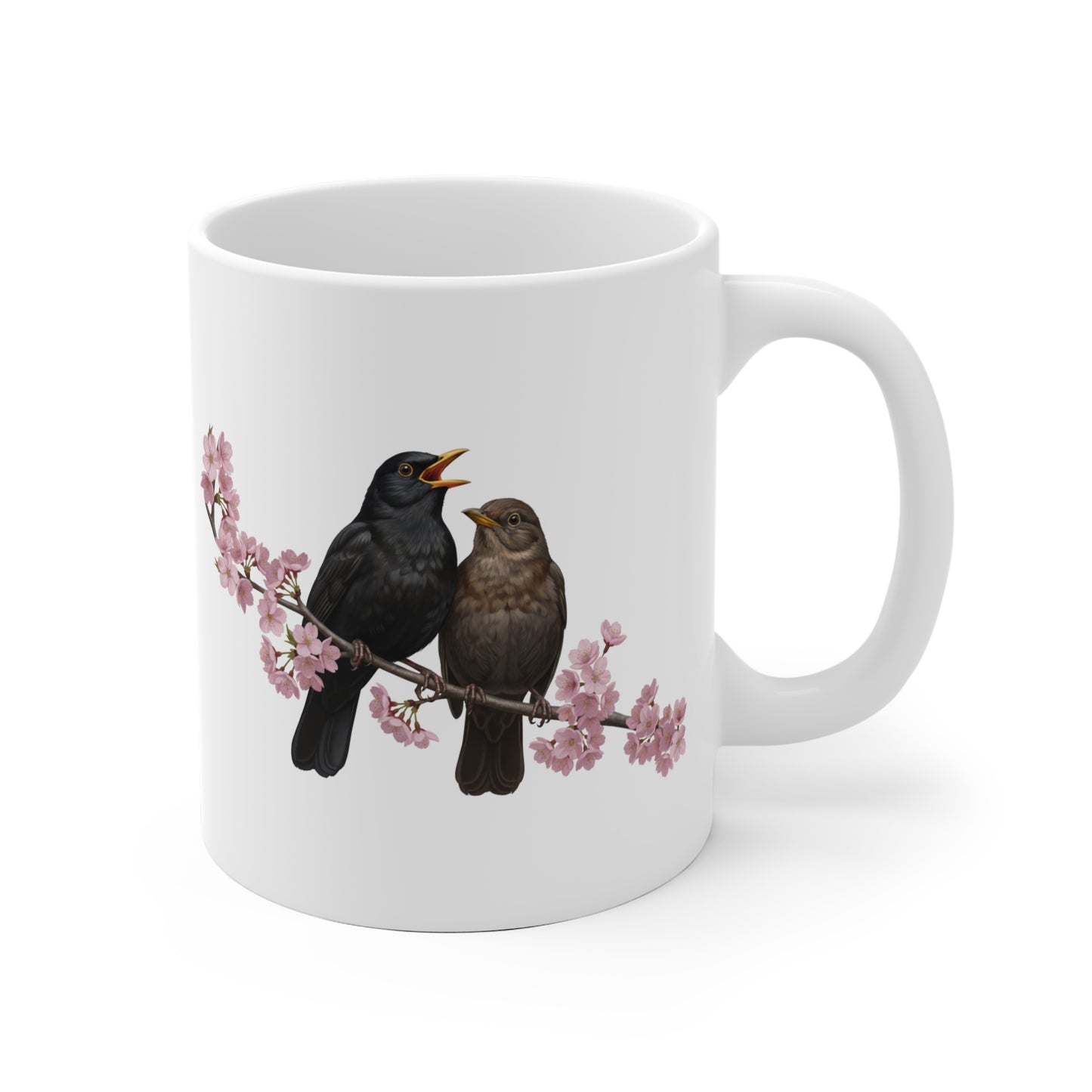 White mug with black birds on a branch design on a white background
