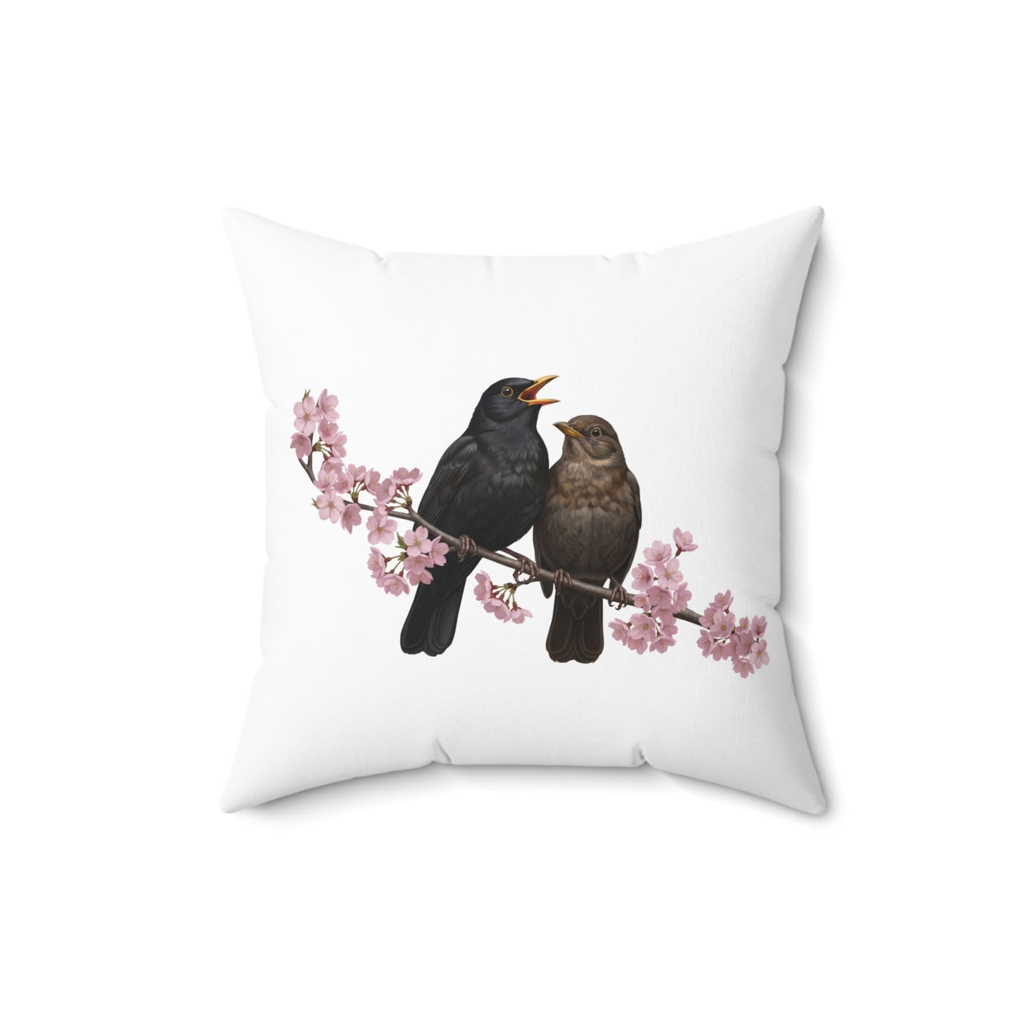 White pillow with black birds on a branch with cherry blossoms design on a white background