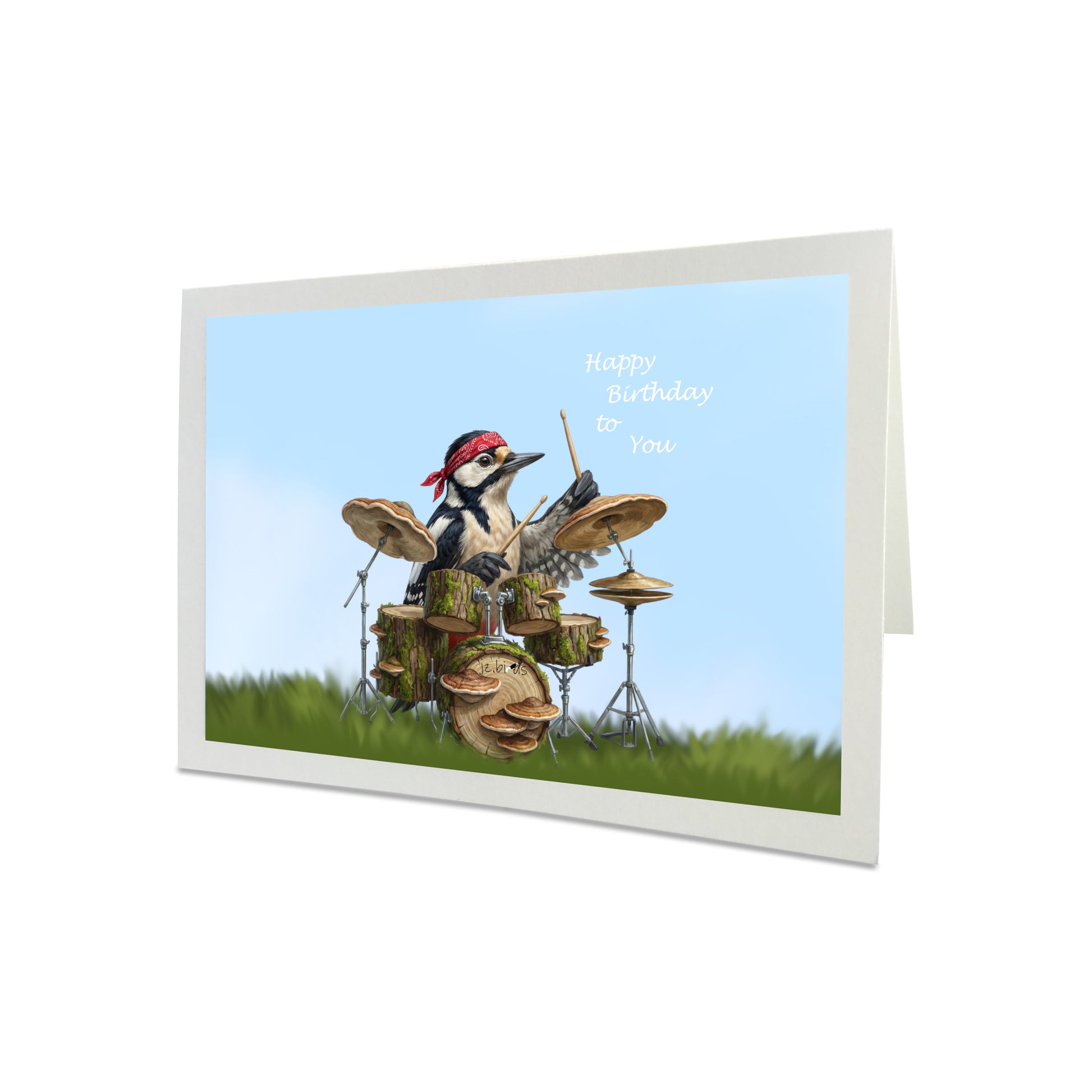 Birthday card with a woodpecker playing drums on a grassy field