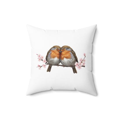 Decorative pillow with two birds on a branch with cherry blossoms design on a white background