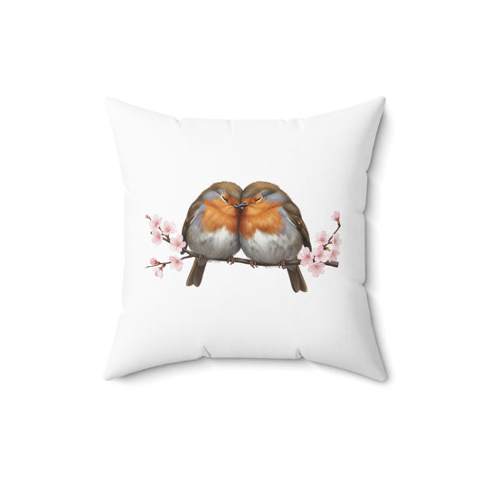 Decorative pillow with two birds on a branch with cherry blossoms design on a white background