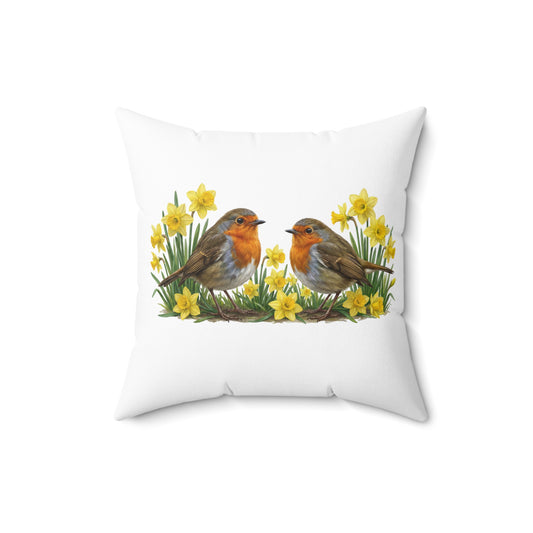 weißes kissen mit einem gemalten motiv von 2 rotkehlchen, die umgeben sind von osterglocken