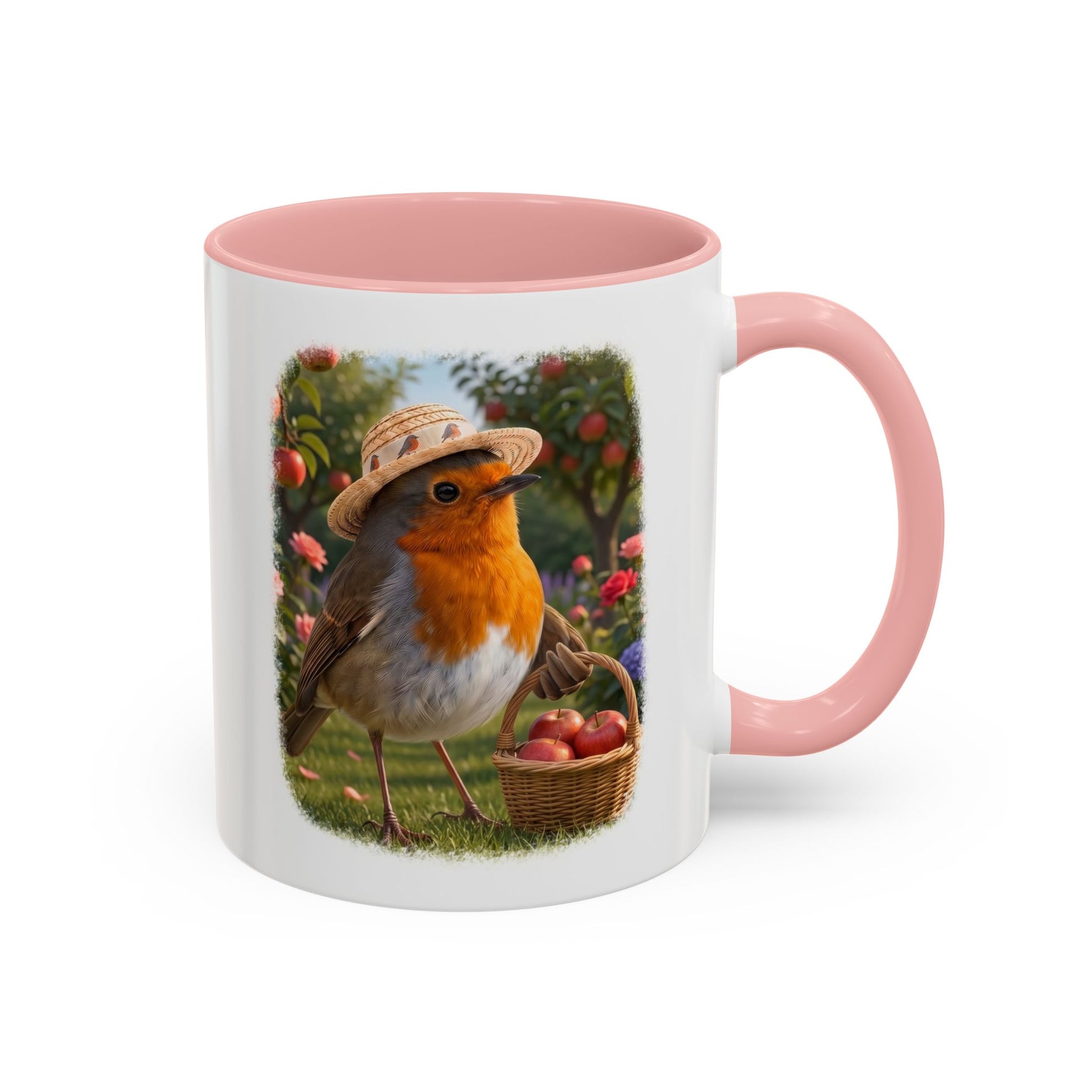 Weiße Keramiktasse mit rosa Henkel und Innenseite. Das aufgedruckte Motiv zeigt eine digitale Illustration von einem Rotkehlchen namens Rosi, das einen Sonnenhut trägt und mit einem vollen Apfelkörbchen im Flügel unter Apfelbäumen steht.
